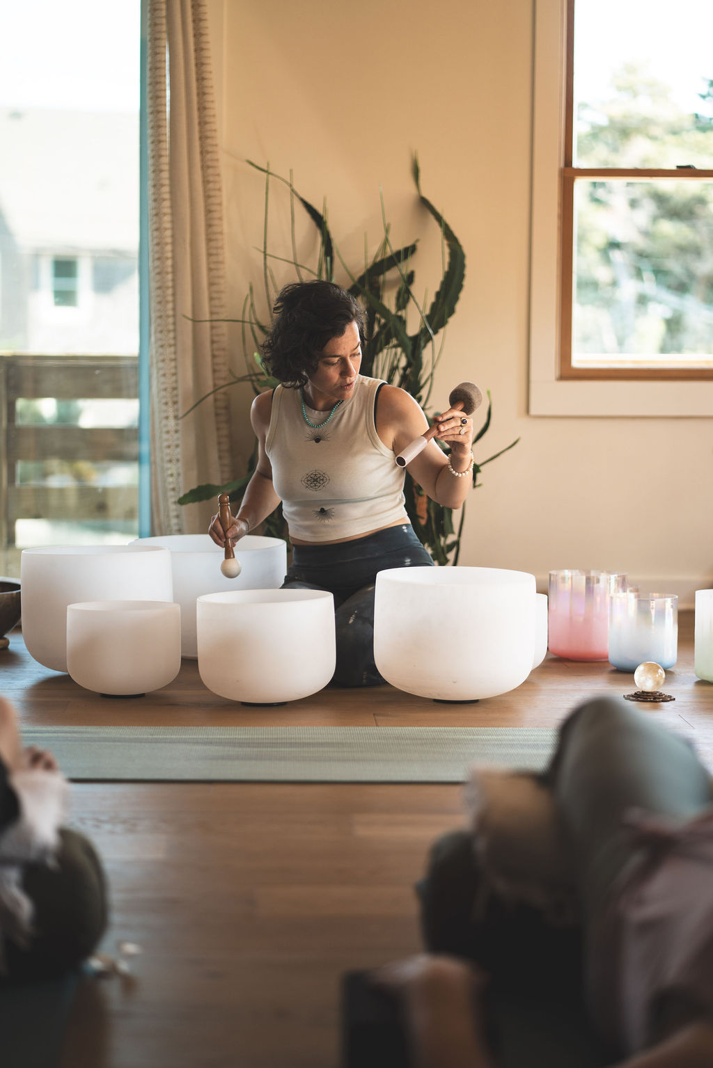 Brooke playing crystal singing bowls for a small group